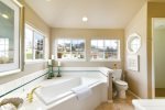 The Master Bathroom is beautifully tiled and has a large tub, separate shower and double sinks.